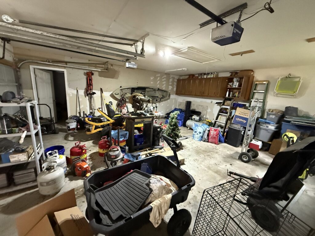 A messy garage filled with items needing a cleanout service from Clear Your Junk - Pearland in Houston, TX.