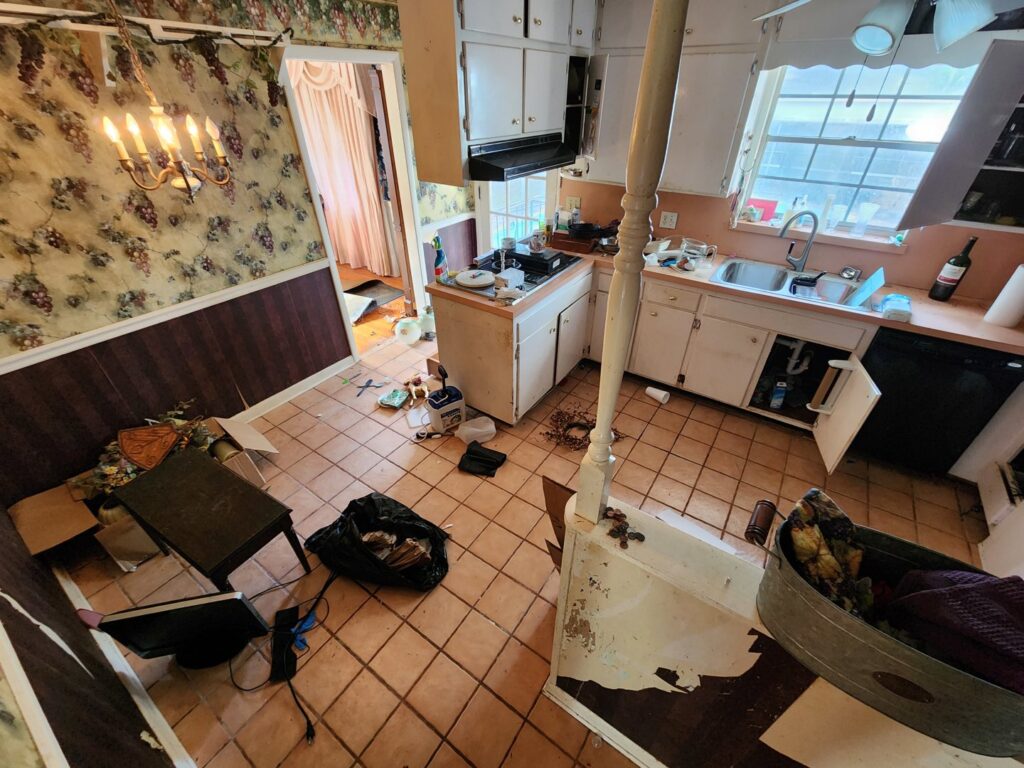 A messy kitchen filled with clutter and old items before a junk removal cleanout by The Mess Haul in Jacksonville, FL.