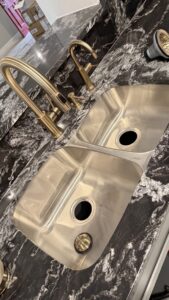 A new kitchen sink and gold-toned faucet installation by Economy Plumbing Services in Austin, TX