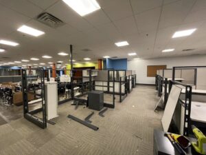 Office cubicles being dismantled for commercial junk removal and cleanout by G.I. HAUL in Austin, TX.