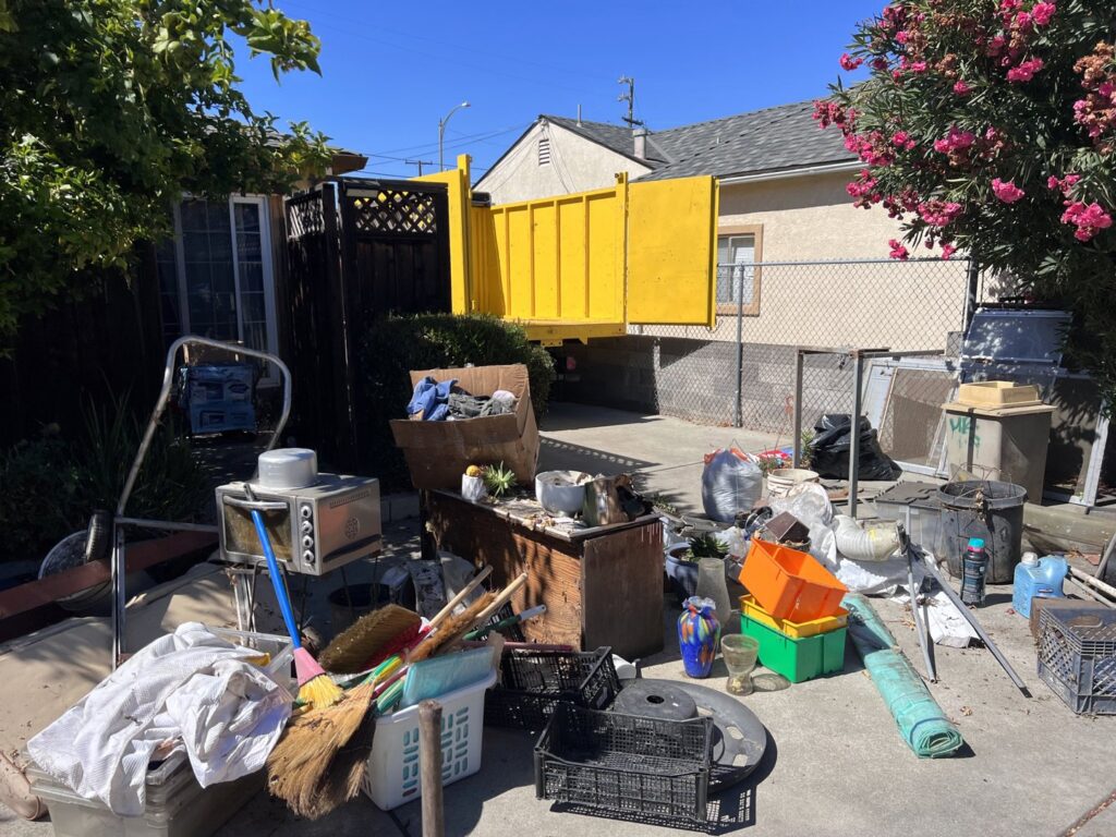 An office space with disassembled cubicles and construction debris, being cleared by Zero Junk in San Jose, CA.