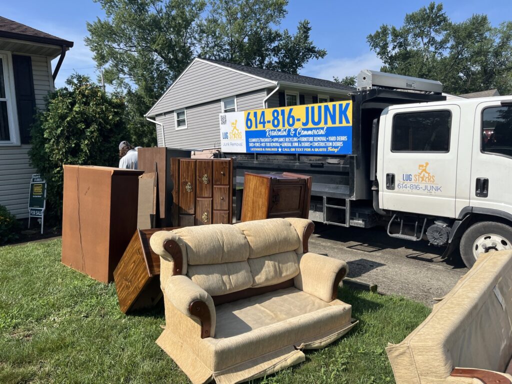 A pile of old furniture in a yard awaiting removal by Lug Stars Junk Removal in Columbus, OH.