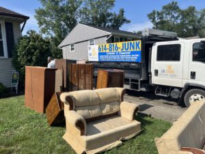 A pile of old furniture in a yard awaiting removal by Lug Stars Junk Removal in Columbus, OH.