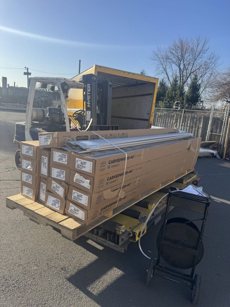 The interior of a High Speed Junk Removal truck in Levittown, PA, filled with numerous old windows for disposal.