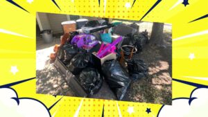 A large pile of outdoor junk, including black trash bags and various household items, ready for removal by IREP Junk Removal ATX in Austin, TX.