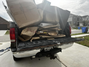 A pickup truck loaded with various cardboard boxes for removal by ONLY Junk Removal Services in Austin, TX