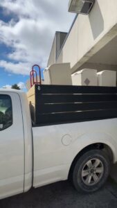 A pickup truck loaded with old fixtures and junk, ready for removal by Indy Trash Guy in Fortville, IN.