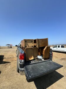A pickup truck loaded with wooden furniture pieces, ready for hauling by Johan's Junk Removal and Hauling in San Diego, CA.