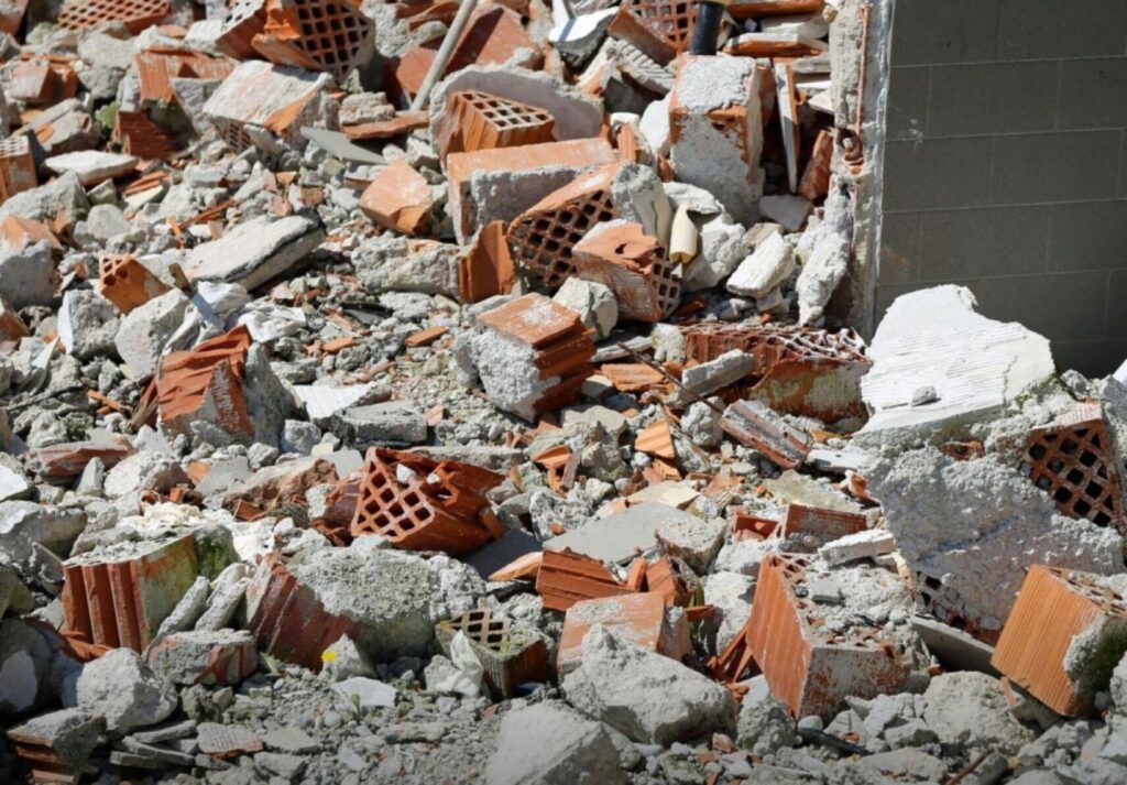 A close-up view of a pile of broken bricks and concrete rubble, indicating a debris removal job by Zen Junk in San Jose, CA.