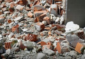 A close-up view of a pile of broken bricks and concrete rubble, indicating a debris removal job by Zen Junk in San Jose, CA.