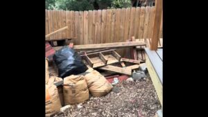 A pile of wood, bags, and general debris awaiting removal by Texas Strong Hauling and Junk Removal in San Antonio, TX.