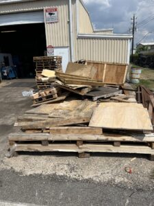 A large pile of wooden pallets and other wood debris awaiting general junk removal by Get Junk Help in Houston, TX.