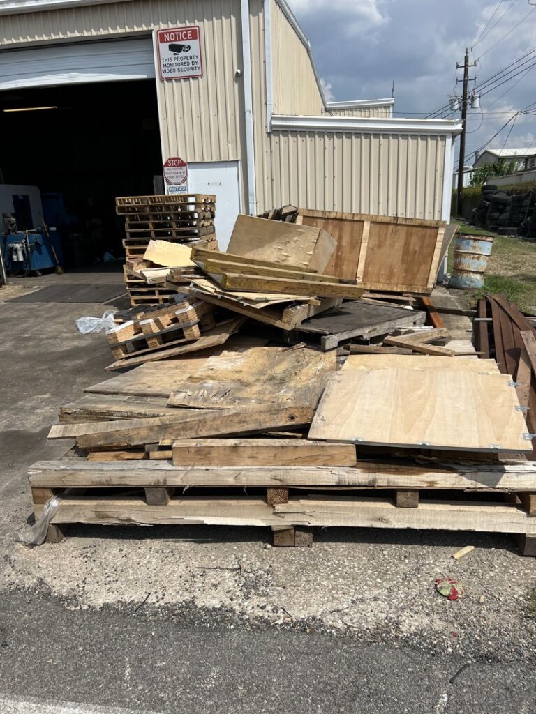 A large pile of wooden pallets and other wood debris awaiting general junk removal by Get Junk Help in Houston, TX.