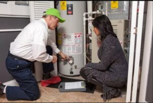 A plumber from JG Water Heaters, Filtration and Plumbing explaining water heater service to a client in San Diego, CA