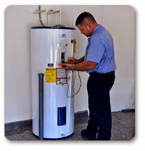 A plumber servicing a water heater for Reliable Plumbing Services in Houston, TX