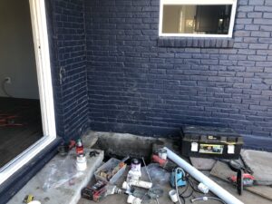 Plumbing tools and pipes next to an open trench during a job by Economy Plumbing Services in Austin, TX