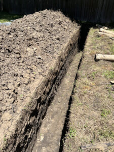 A plumbing trench dug for new pipe installation or repair by Molberg Plumbing in Ft Worth, TX
