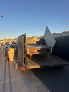A pool table and other large items loaded onto a trailer for junk removal by Power Haulers & Junk Removal LLC in Phoenix, AZ.
