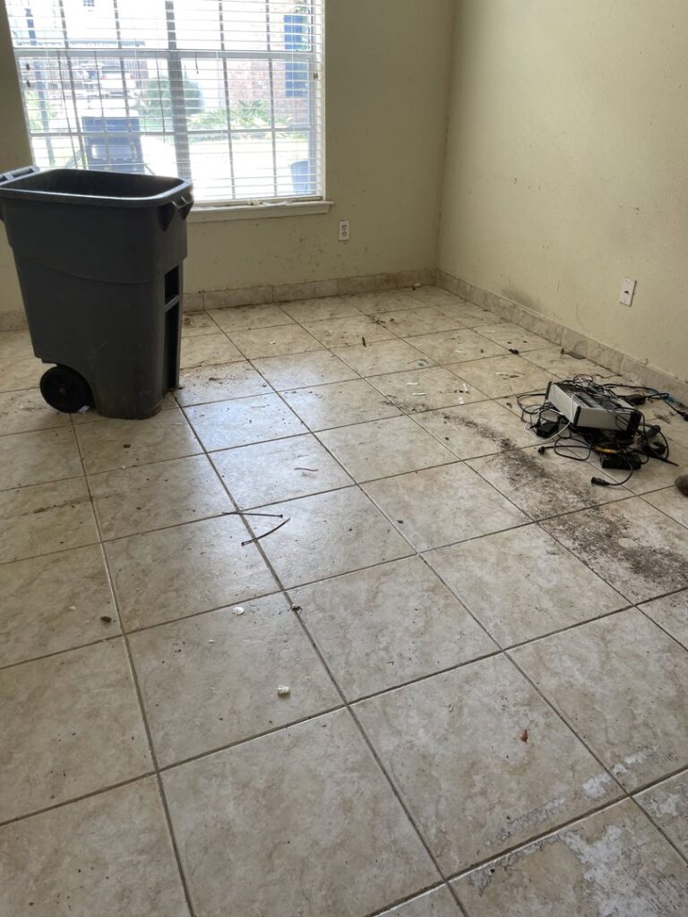A room with debris on the floor, ready for cleanout by Right On Time Junk Removal in Houston, TX.