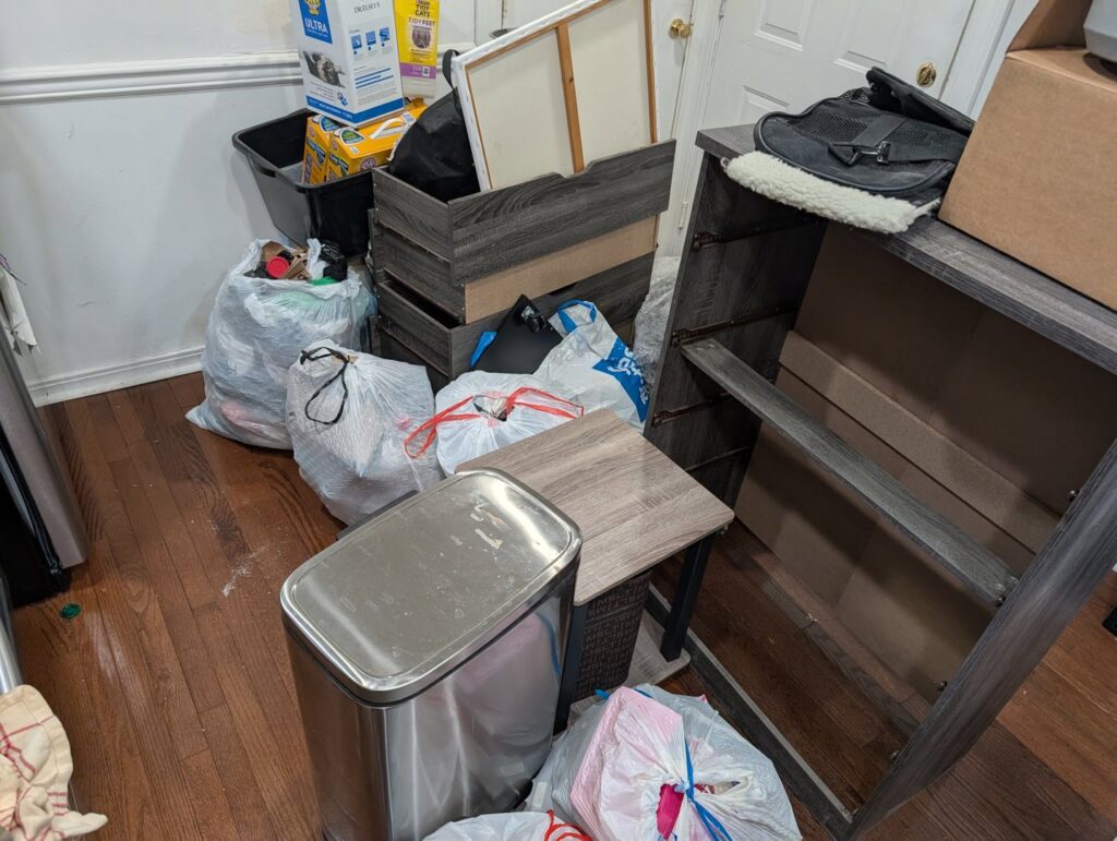 A room full of trash bags, boxes, and old furniture awaiting junk removal by GEF Hauling and Junk Removal in Philadelphia, PA.