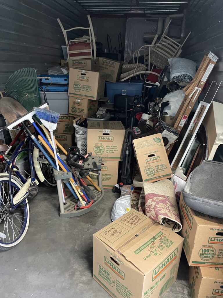 A cluttered storage unit filled with various items, indicating a large junk removal or cleanout job for Cee J Junk Removal LLC in Phoenix, AZ.