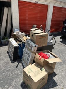 A pile of various items including boxes, mattresses, and a bike outside storage units, ready for junk removal by ABC Junk Removal & Hauling in Westfield, IN.