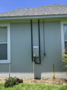 Outdoor tankless water heater installation by David Gray- Electrical Plumbing Heating & Air in Jacksonville, FL