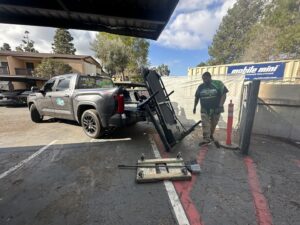 A Haul Away Any Day team member moving a treadmill for removal in San Diego, CA.