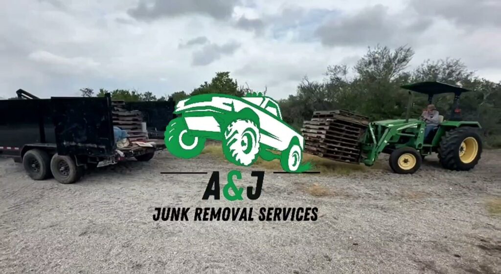 A tractor moving a stack of wooden pallets towards a dump trailer for removal by A&J Removal Service in San Antonio, TX.