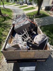 A trailer loaded with old furniture and debris after a junk removal job by Big John's Demolition & Junk Removal in Charlotte, NC