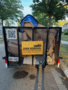 A Load & Go Hauling Junk Removal trailer filled with various items of junk after a residential pickup in Grove City, OH.