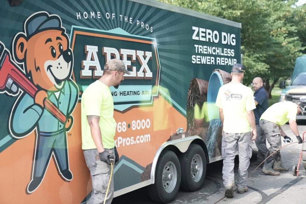 Technicians performing trenchless sewer repair service with specialized equipment from Apex Pros Plumbing, Electric, Heating, and Air in Columbus, OH.