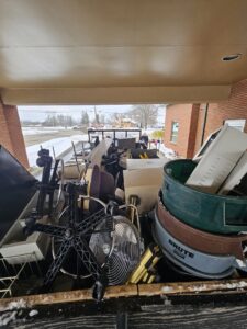 A truck bed loaded with various office furniture, fans, and other junk items after a removal job by Purefoy's Professionals in Columbus, OH.