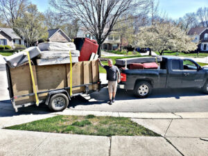 A truck and trailer loaded with furniture and mattresses after a junk removal job by Indy Trash Guy in Fortville, IN.