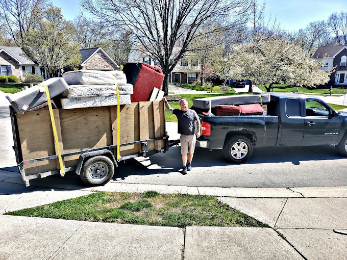 A truck and trailer loaded with furniture and mattresses after a junk removal job by Indy Trash Guy in Fortville, IN.