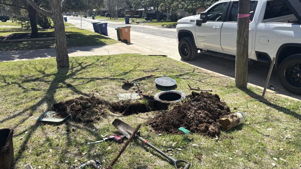 An excavated area in a yard for underground plumbing repair or installation by Economy Plumbing Services in Austin, TX