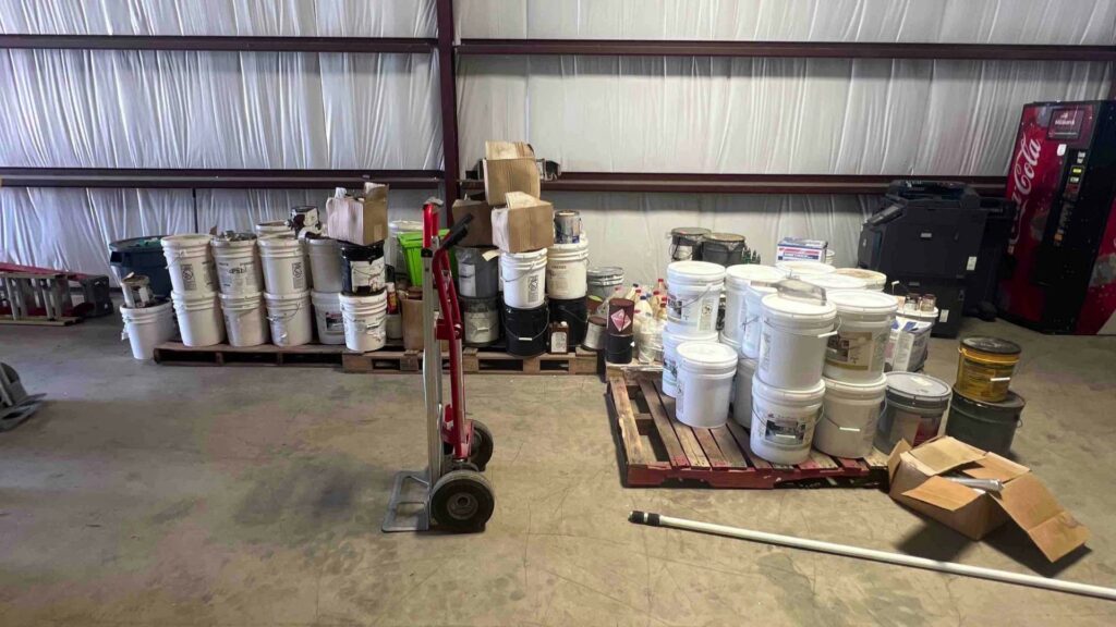 A warehouse filled with numerous buckets and containers ready for general junk removal by IREP Junk Removal ATX in Austin, TX.