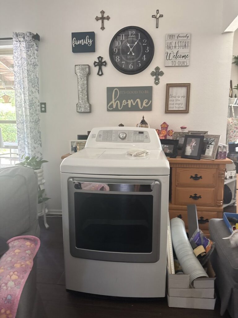 A white washing machine or dryer in a living room, ready for appliance removal by A&J Removal Service in San Antonio, TX.