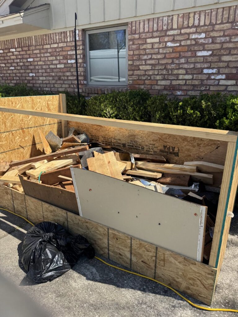 A large wooden crate filled with wood scraps and construction debris, ready for removal by HustleTown Junk Removal in Houston, TX.