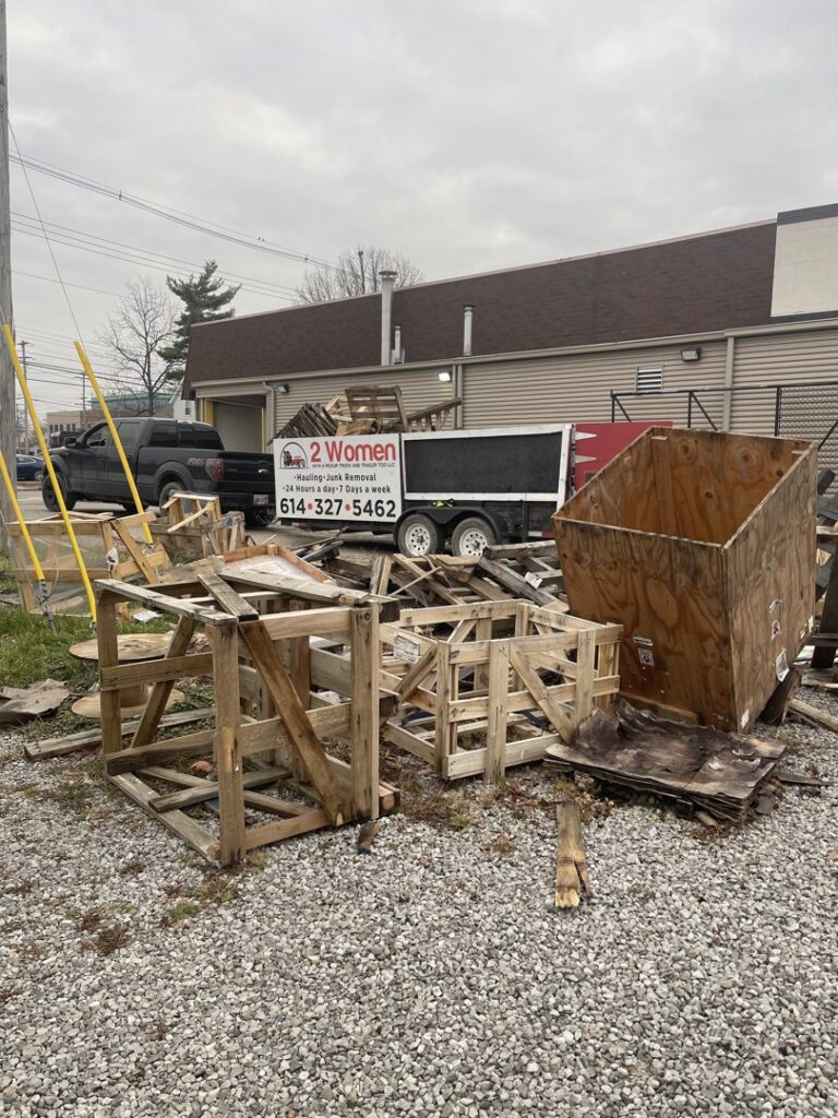 A pile of wooden crates and debris awaiting junk removal by 2 Women with a Pickup Truck and Trailer Too LLC in Columbus, OH.
