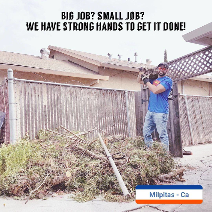 A worker hauling yard debris for Strong Hands Hauling & Dumpster Rental in San Jose, CA
