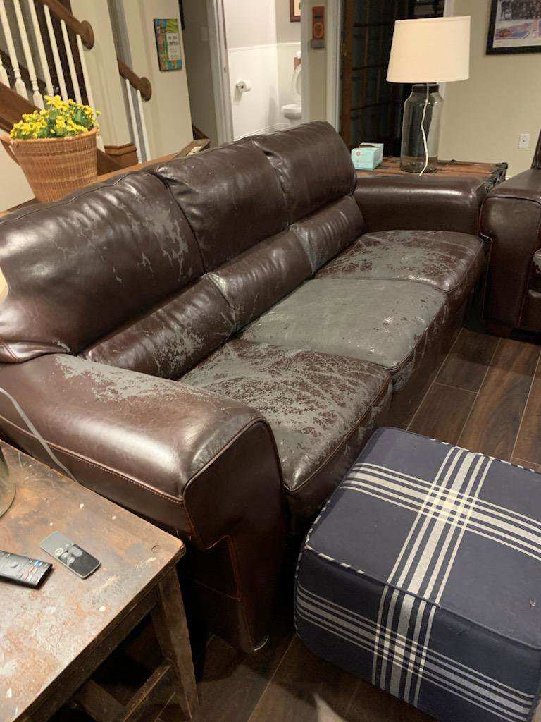 A worn-out leather sofa with peeling upholstery, ready for junk removal by ABC Junk Removal & Hauling in Westfield, IN.